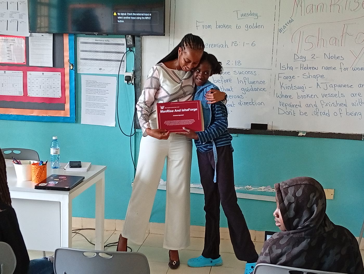 A mentee receiving a certificate at graduation