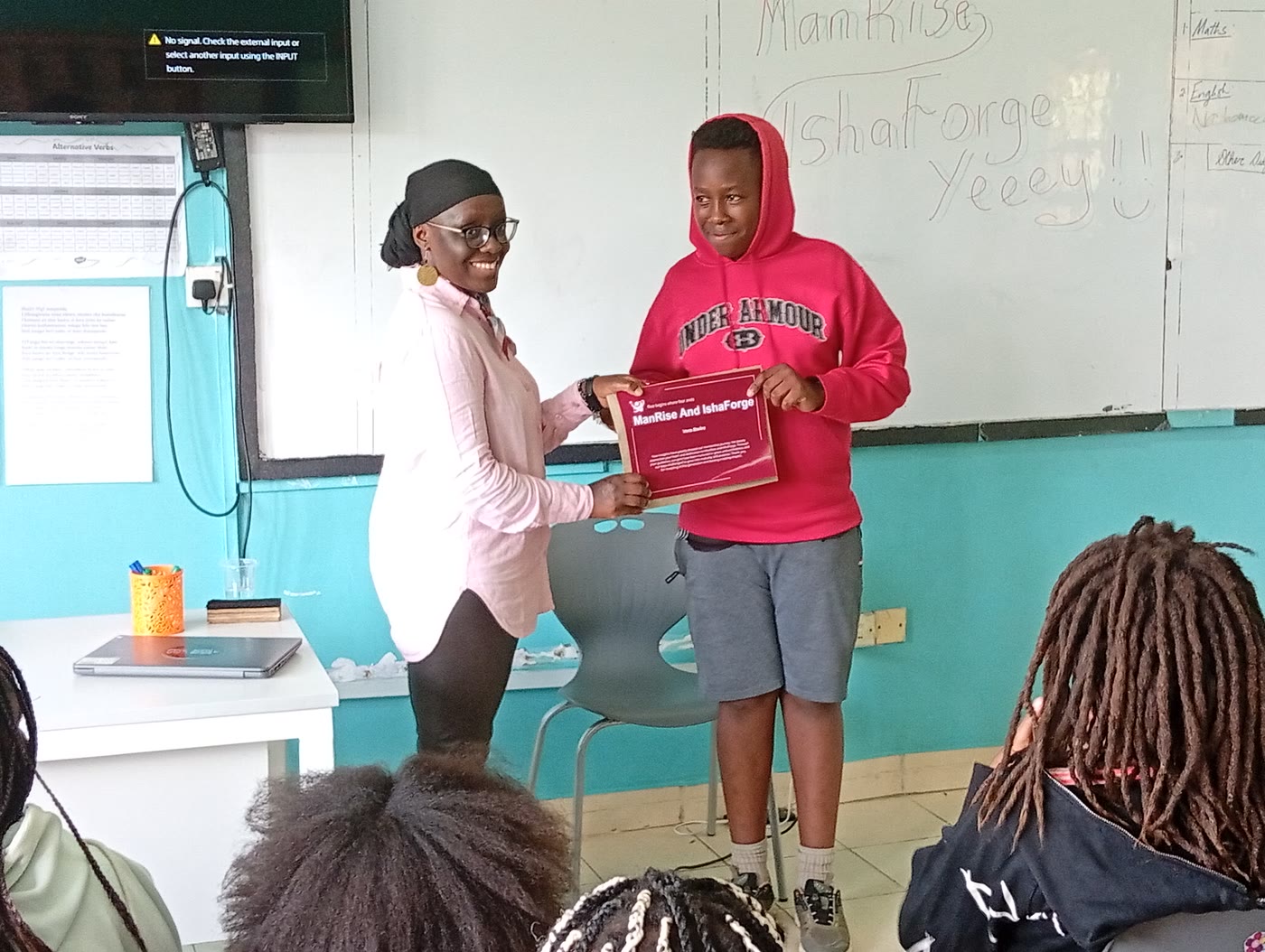 A certificate handover at a cohort graduation
