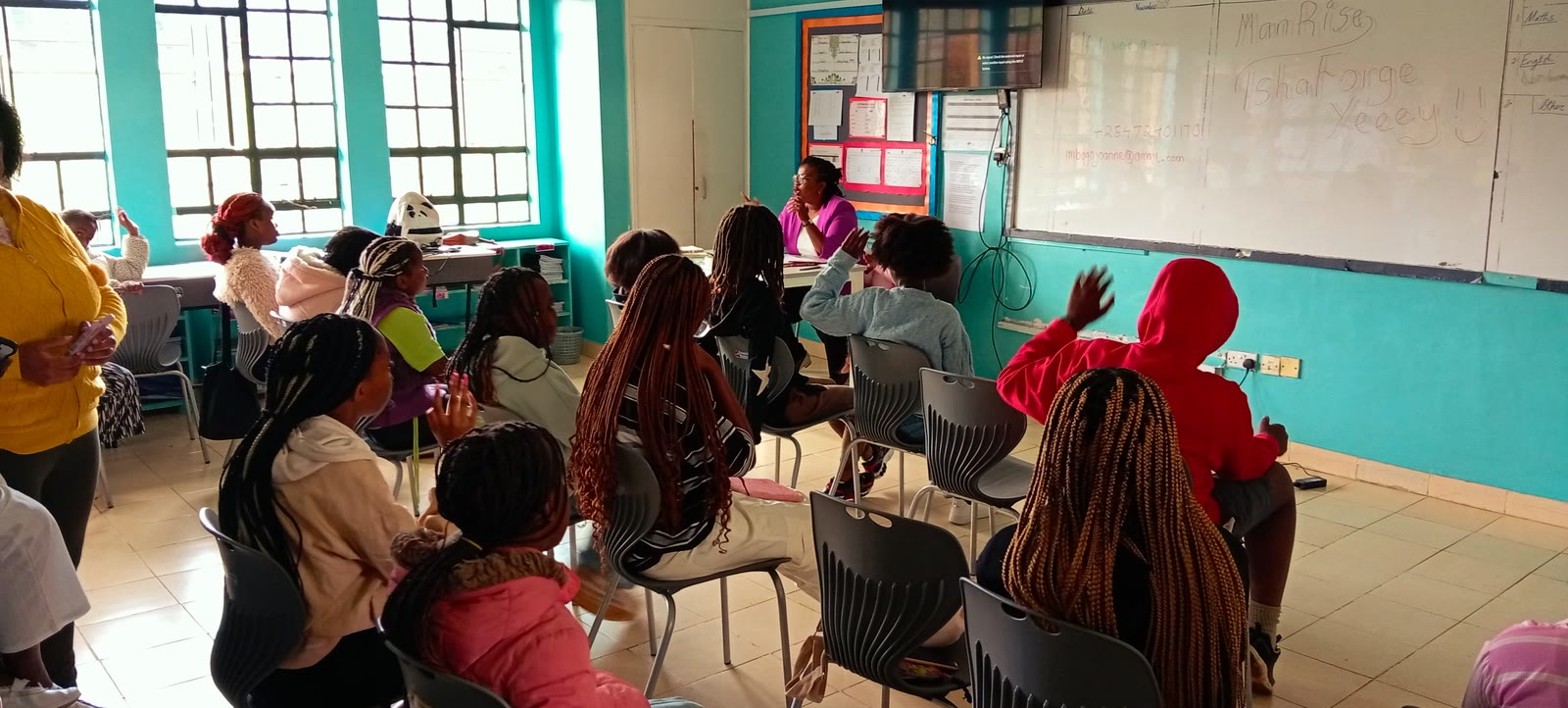 Girls raising their hands during an IshaForge session