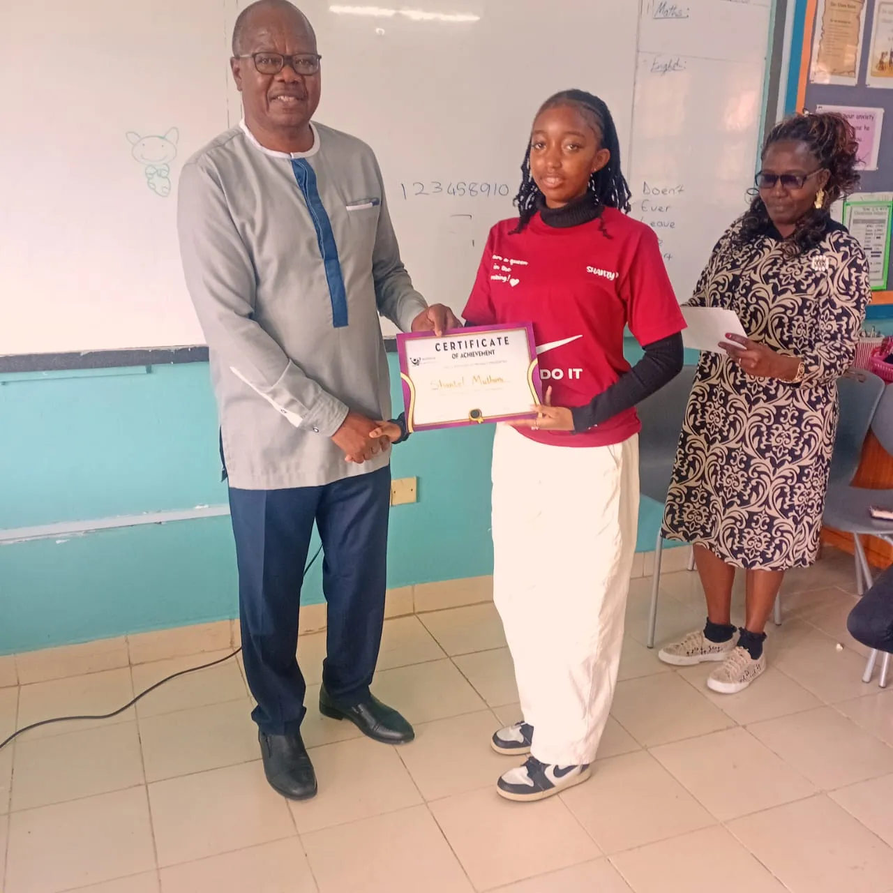 A young lady receiving her graduation certificate