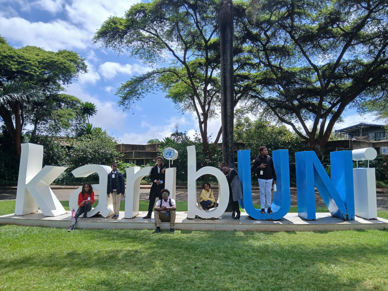 Our youth at the KaribUNI sign during a United Nations visit in Nairobi